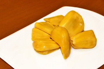 Ripe Jackfruit on white tray and brown background. Sweet & sour tropical fruit.