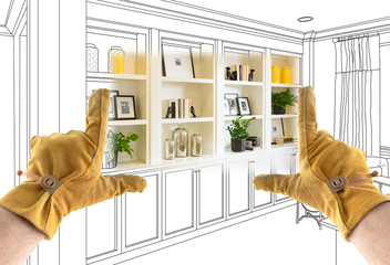 Male Contractor Hands Framing Completed Section of Built In Shelving Over Drawing