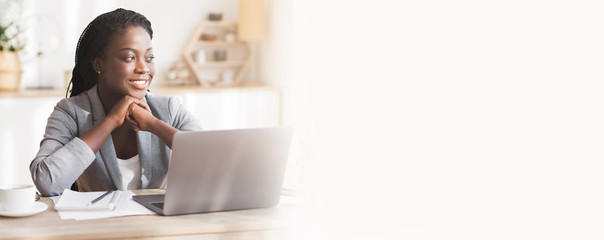 Portrait of smiling african american businesswoman at workplace in office