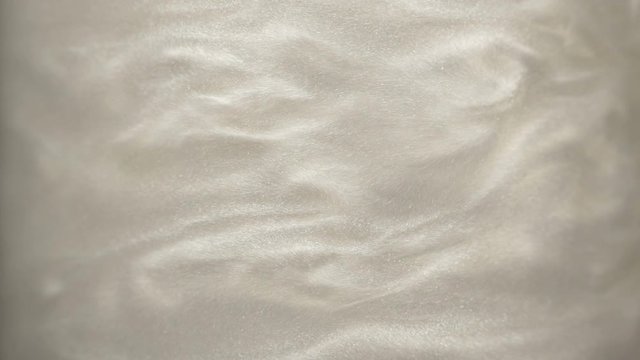 Rheoscopic fluid. Beautiful movement of particles in a liquid. Fantastic patterns and shapes.