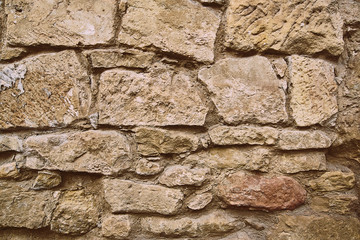 sandstone wall with stones as a background
