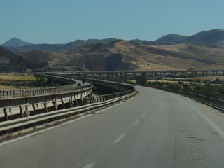panorama in the highway crossing Sicily island from Palermo to Catania along long bridges through arid valleys