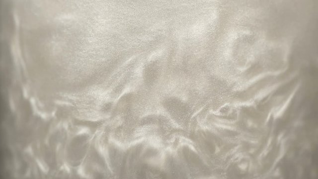 Rheoscopic fluid. Beautiful movement of particles in a liquid. Fantastic patterns and shapes.