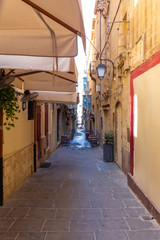 tiny narrow street in the city of Valetta Malta
