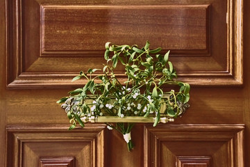 wooden door decorated with flowers at Christmas