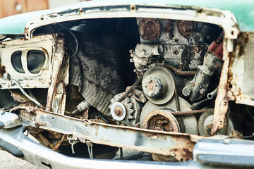 Details of old car. Aged oldtimer vintage automobile. Spare parts of retro classic automobile. Disassembled car in a parking lot.