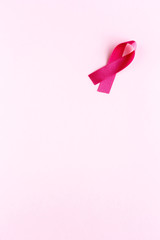 Pink ribbon on a colored background