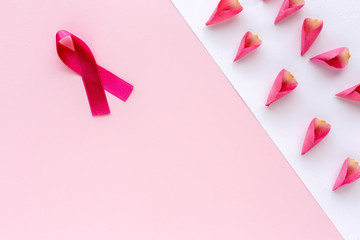 Pink ribbon on a colored background. Cancer