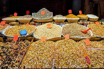 View of the most delicious types of fresh beans, grains and seeds, clearly arranged in various bins at a market place in Istanbul Turkey.