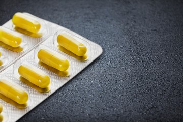 Yellow Pills or capsule in Packages on desk
