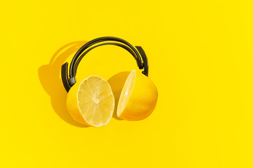 Yellow citrus headphones. Creative concept for summer parties.	