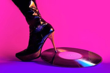 Vinyl record under the heel of a female shoe. Creative concept of a hot bachelorette party. - 314126844