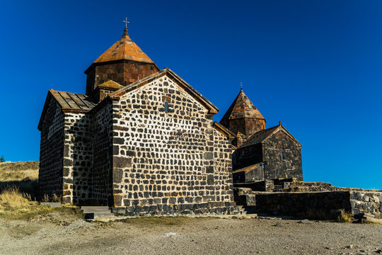 Old orthodox monastery Sevanavank located on a peninsula at the northwestern shore of Lake Sevan in Armenia. View during autumn sunny day 