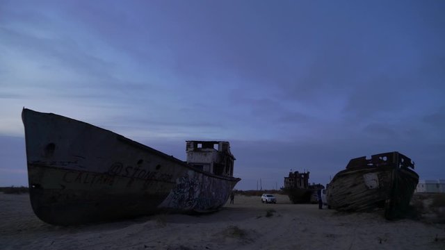 abandoned ships at the bottom of the dried sea Aral car with tourists 4k