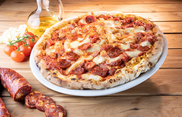 pizza with salami on the wooden table