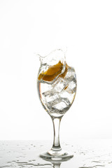 Mineral water with ice cubes and lemon slice