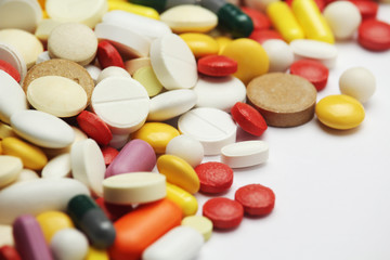 Different colorful tablets at white background	