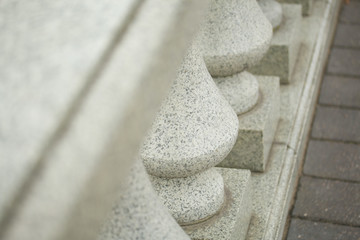 Fototapeta na wymiar Elements of urban architecture. Fragments of a handrail from granite.
