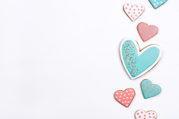 Gingerbread cookies with frosting in the shape of a heart on white background. Valentines day concept. Flat lay, top view, copy space for text.