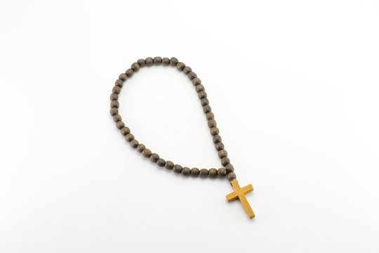 Rosary with a cross on a white background. Religion.