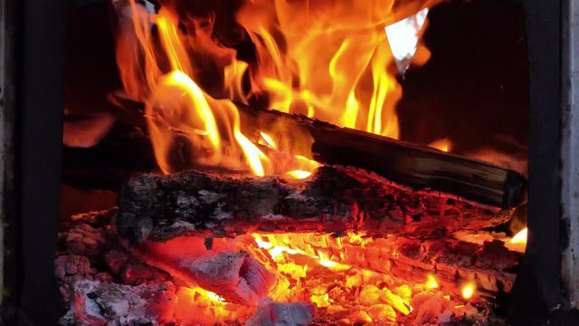 Macro video of a fire in a street fireplace. Firewood burns beautifully and an atmosphere of relaxation, comfort and hearth will be created. Close-up