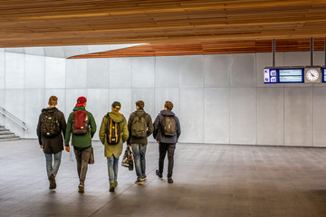 Group of five boys on their way out in a railway station