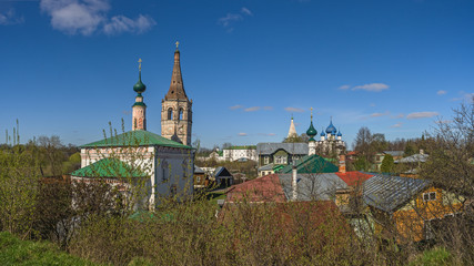 The paints of a spring sunny day. Roofs of the preserved old city block. View from the Kremlin ramparts. The Golden Ring of Russia, Suzdal. Panorama