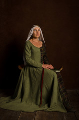 Beautiful sophisticated girl actress in a medieval costume of the 14th century central Europe....