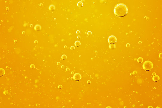 Oil background. Golden liquid with air bubbles on white background  for projects, oil, honey, beer, juice, shampoos.