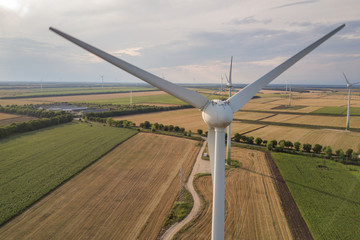 Aerial view of wind turbine generators in field producing clean ecological electricity.