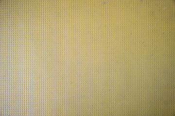 Close up of abstract yellow background with geometric pattern.
