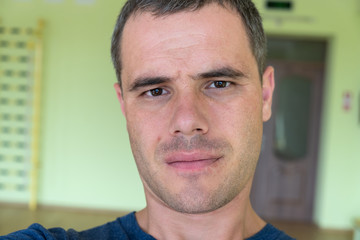 Portrait of a young serious man inside a sports gym.