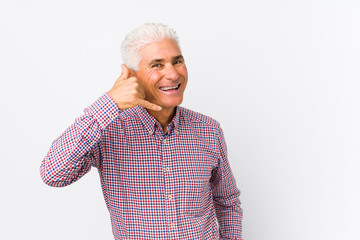 Senior caucasian man isolated showing a mobile phone call gesture with fingers.