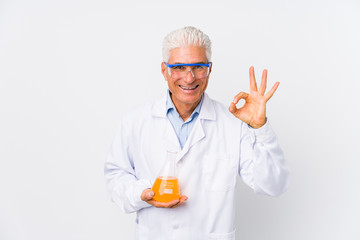 Mature chemical man isolated cheerful and confident showing ok gesture.