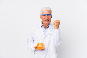 Mature chemical man isolated showing fist to camera, aggressive facial expression.
