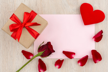 Valentine's Day Concept Gift box, heart, red rose and letter on the wooden table