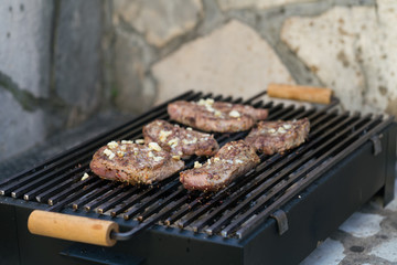 Grilled beef steak on the grill, close-up.