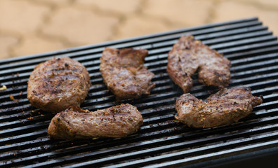 Grilled beef steak on the grill, close-up.