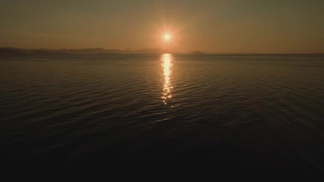 Flying above water away from the sun. Aerial, drone video. Video 2 of 5.