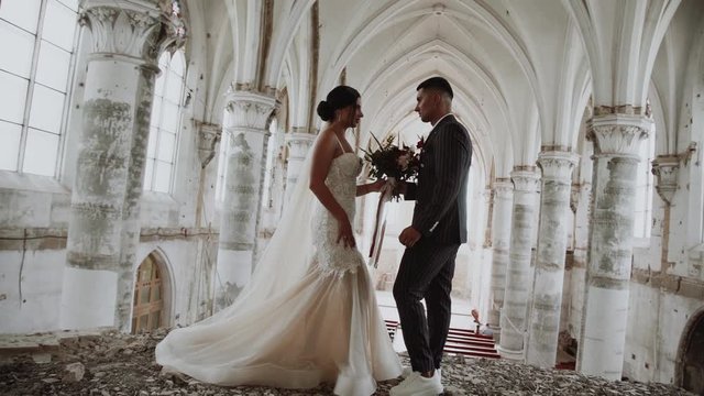 bride and groom in a white abandoned monastery