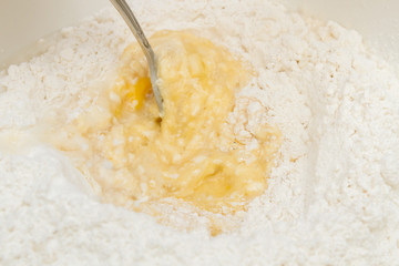 Cooking dough in a white plastic bowl at home