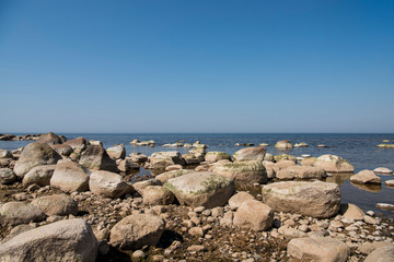 Fototapeta na wymiar Stones balance on the beach. Place on Latvian coasts called Veczemju klintis