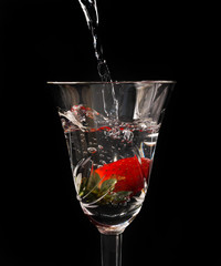 Sweet cocktail with splashes in the dark