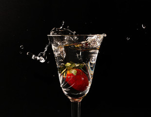 Sweet cocktail with splashes in the dark