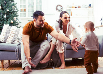 young happy family at home on coach waiting for Christmass with decorated tree, lifestyle people at holiday concept