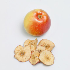 ripe and juicy yellow apple with dried fruit sliced in circles
