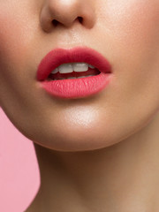 Fototapeta premium close up the beauty of female lips with natural lipstick. kiss on camera. Clean skin and makeup. beautiful girl and lip gloss