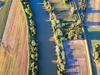Aerial view of river Arno between cultivated fields