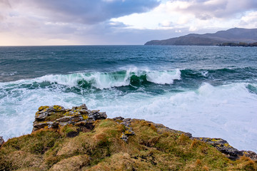 Fototapeta na wymiar Huge waves breaking at Muckross Head - A small peninsula west of Killybegs, County Donegal, Ireland. The cliff rocks are famous for climbing