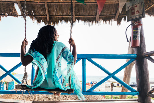 Woman On Swing In Tropics